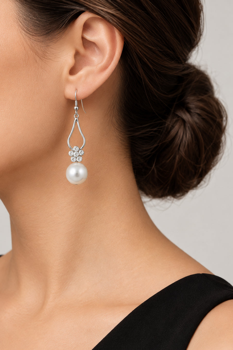 Model wearing crystal flower with dangling pearl pierced earring - Lilylin Designs