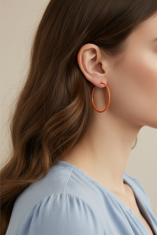 Model wearing orange enamel skinny hoop earring - Lilylin Designs