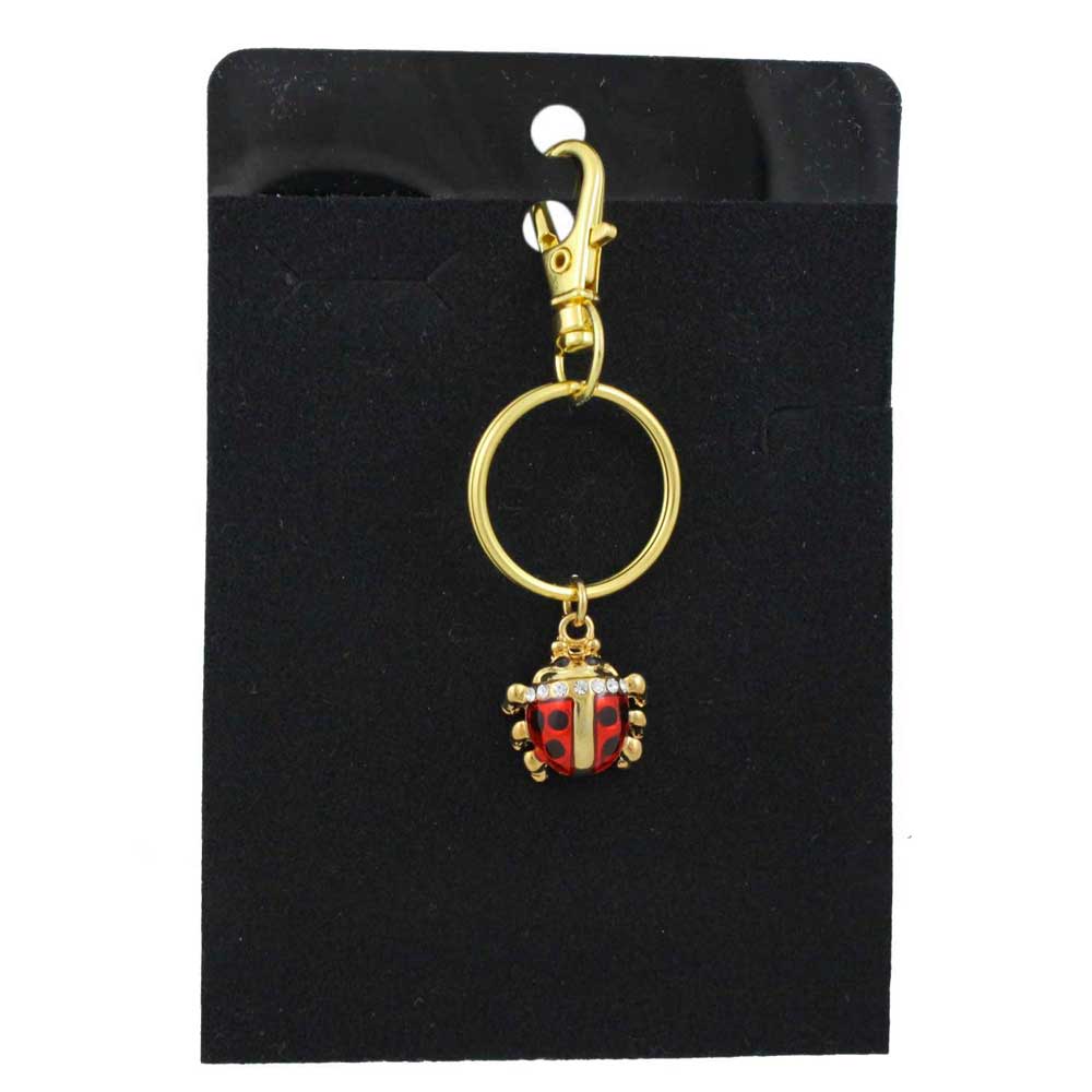 Gold keychain with a red and black ladybug charm on a black card - Lilylin Designs