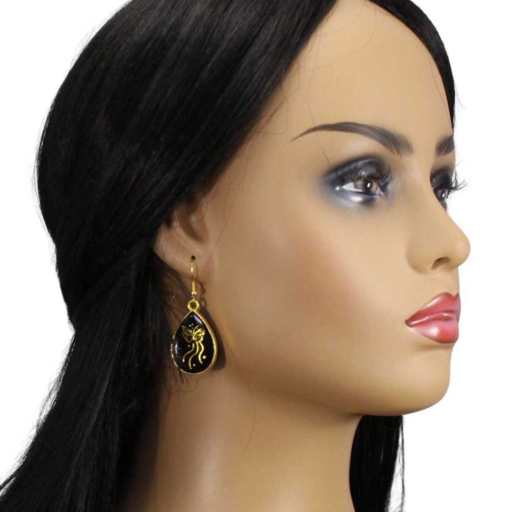 Model with Black teardrop earrings with gold butterfly designs on a white background - Lilylin Designs