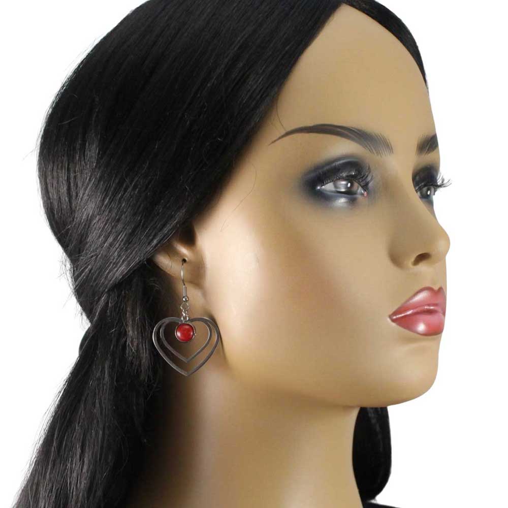 Model wearing Double heart-shaped earrings with red stones on a white background - Lilylin Designs