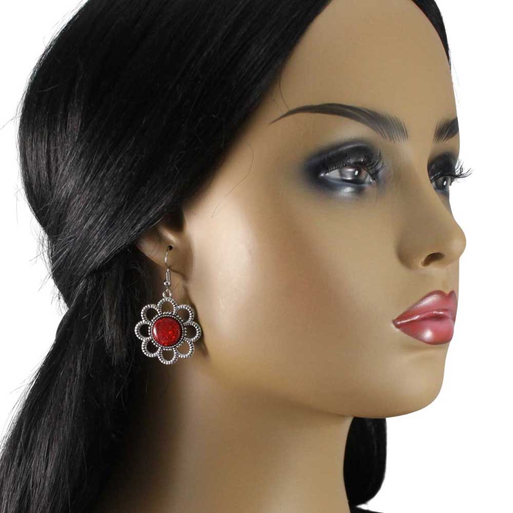 Model wearing pair of earrings with red circular stones and silver floral daisy on a white background - Lilylin Designs