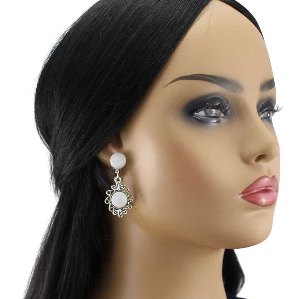 Model wearing Pair of earrings with white round stones and silver floral designs - Lilylin Designs