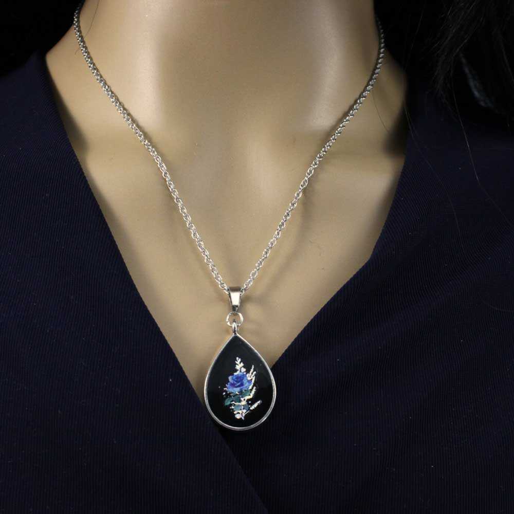 Model with Teardrop-shaped pendant with blue rose on a white background - Lilylin Designs