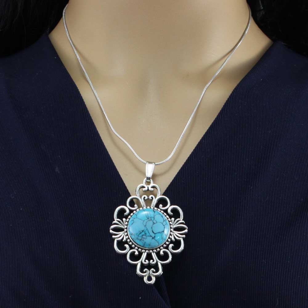 Model wearing silver filigree pendant with simulated turquoise stone - Lilylin Designs