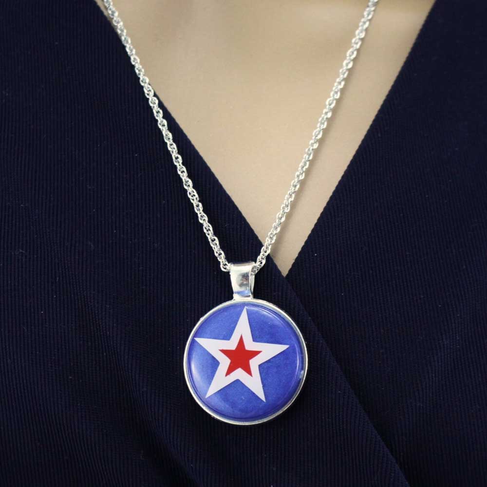 Model wearing a necklace with a round pendant featuring a white and red star on a blue background - Lilylin Designs