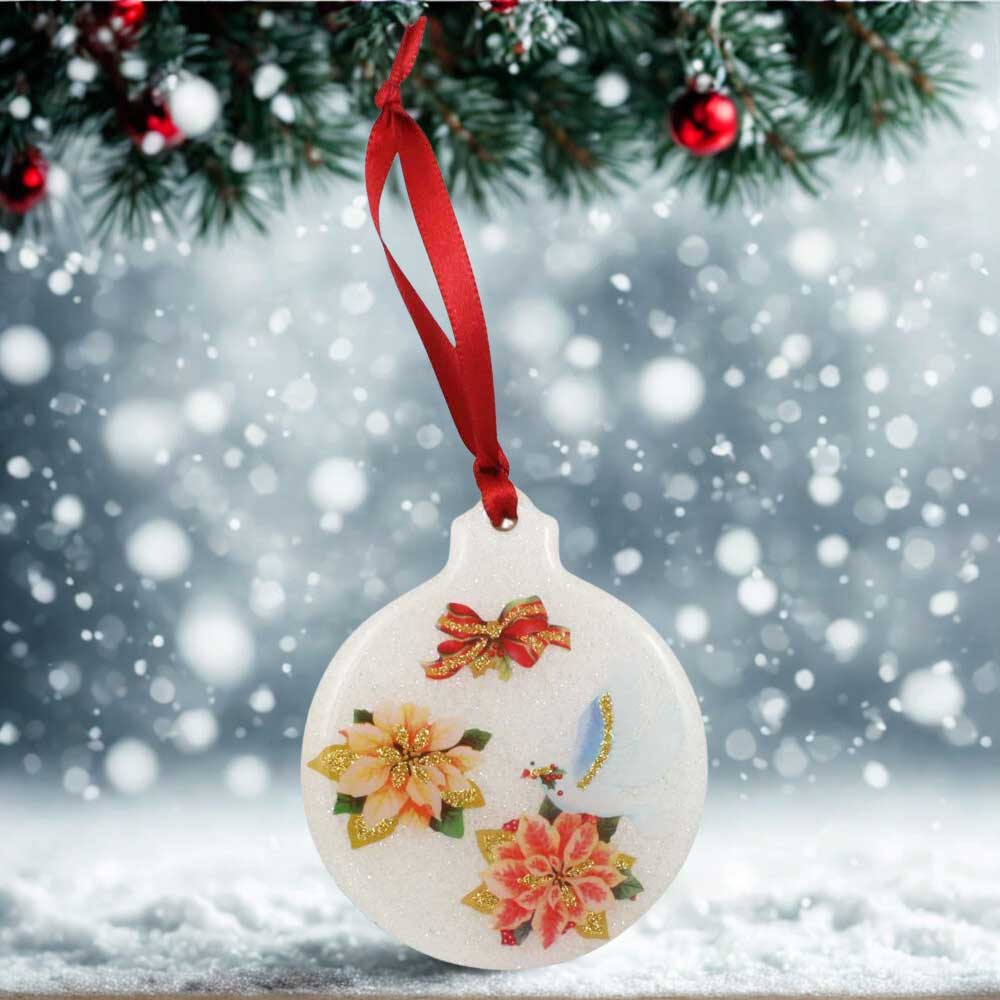 Decorative Christmas ornament with floral designs hanging against a snowy background | Lilylin Designs