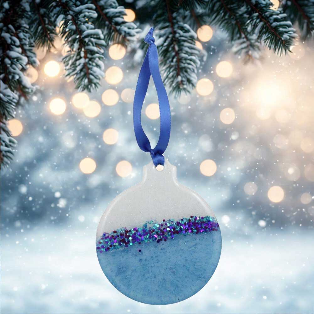 Decorative ornament with blue ribbon against a festive background | Lilylin Designs