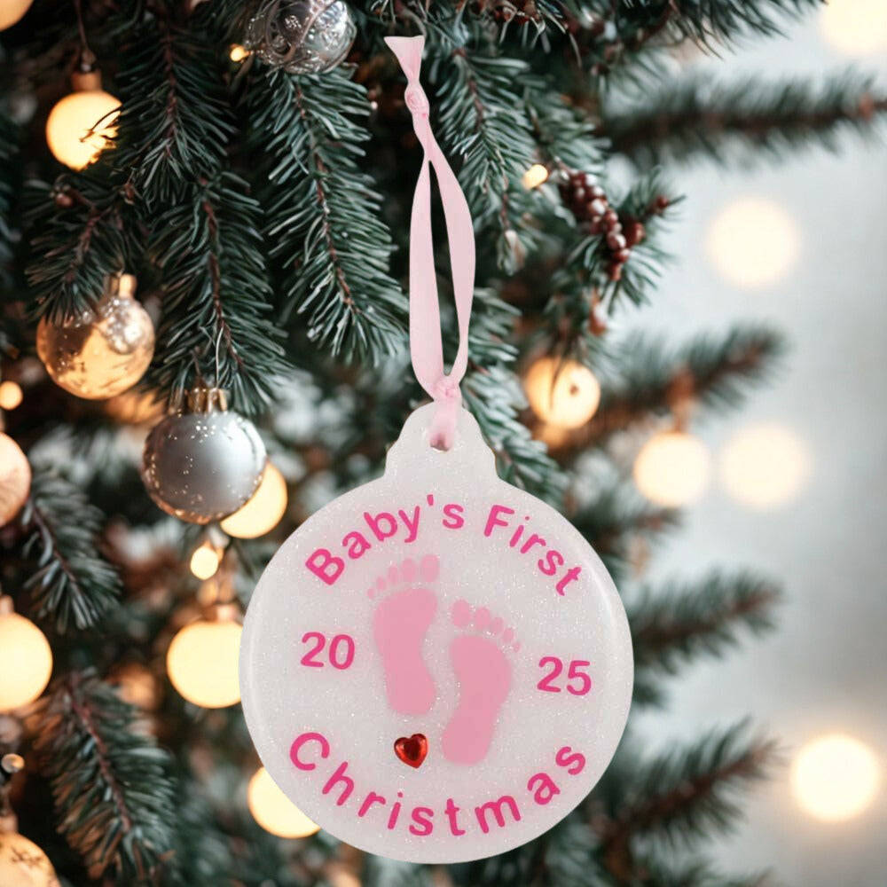 Decorative ornament for 'Baby's First Christmas' hanging on a Christmas tree. | Lilylin Designs