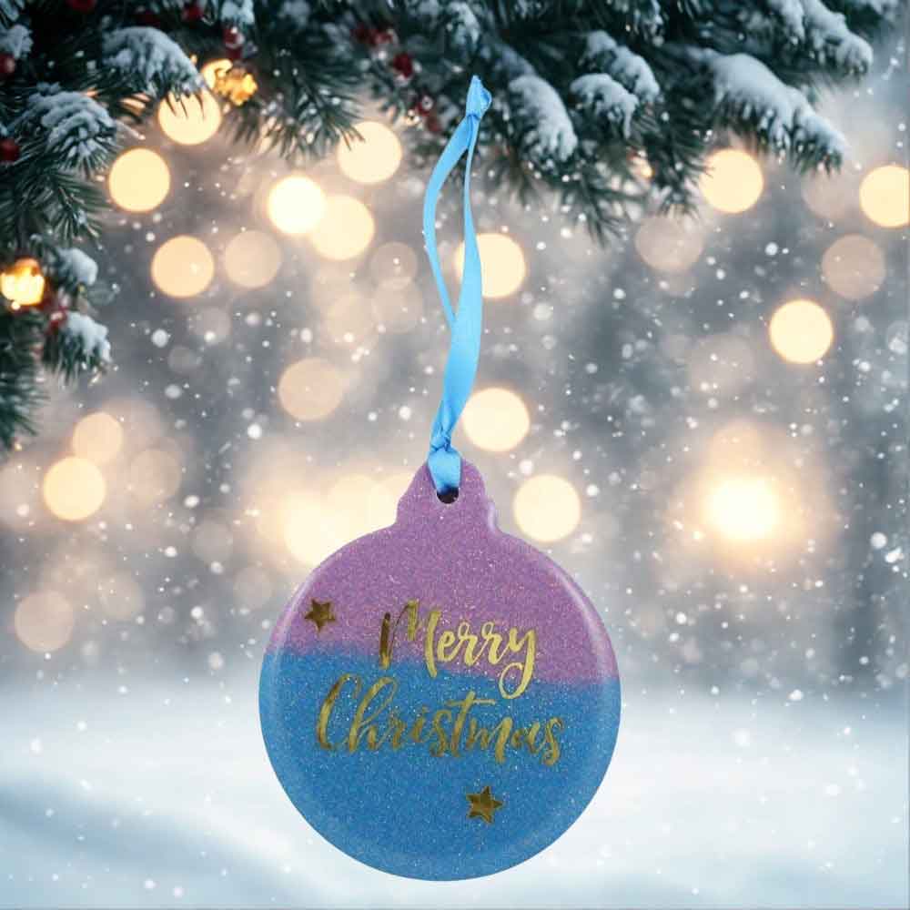 Decorative Christmas ornament with 'Merry Christmas' text on a blurred festive background | Lilylin Designs