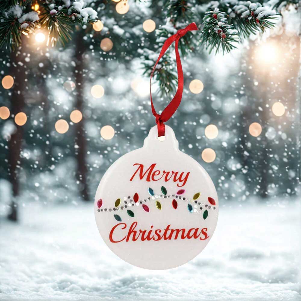 Round Christmas ornament with 'Merry Christmas' text hanging on a tree | Lilylin Designs