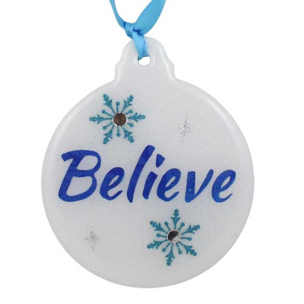 Round white ornament with 'Believe' text and blue snowflakes, attached to a blue ribbon on a white background. | Lilylin Designs