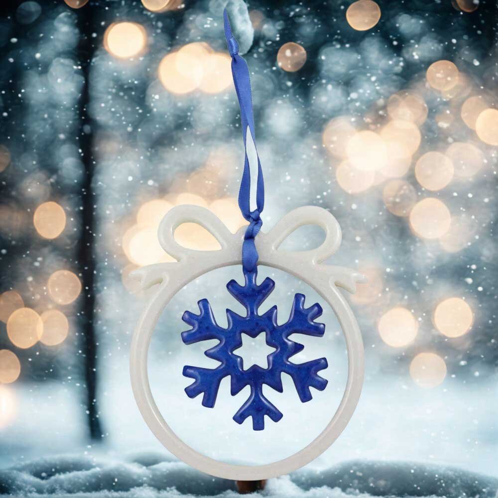 White open bow ornament with blue snowflake against snowy background | Lilylin Designs