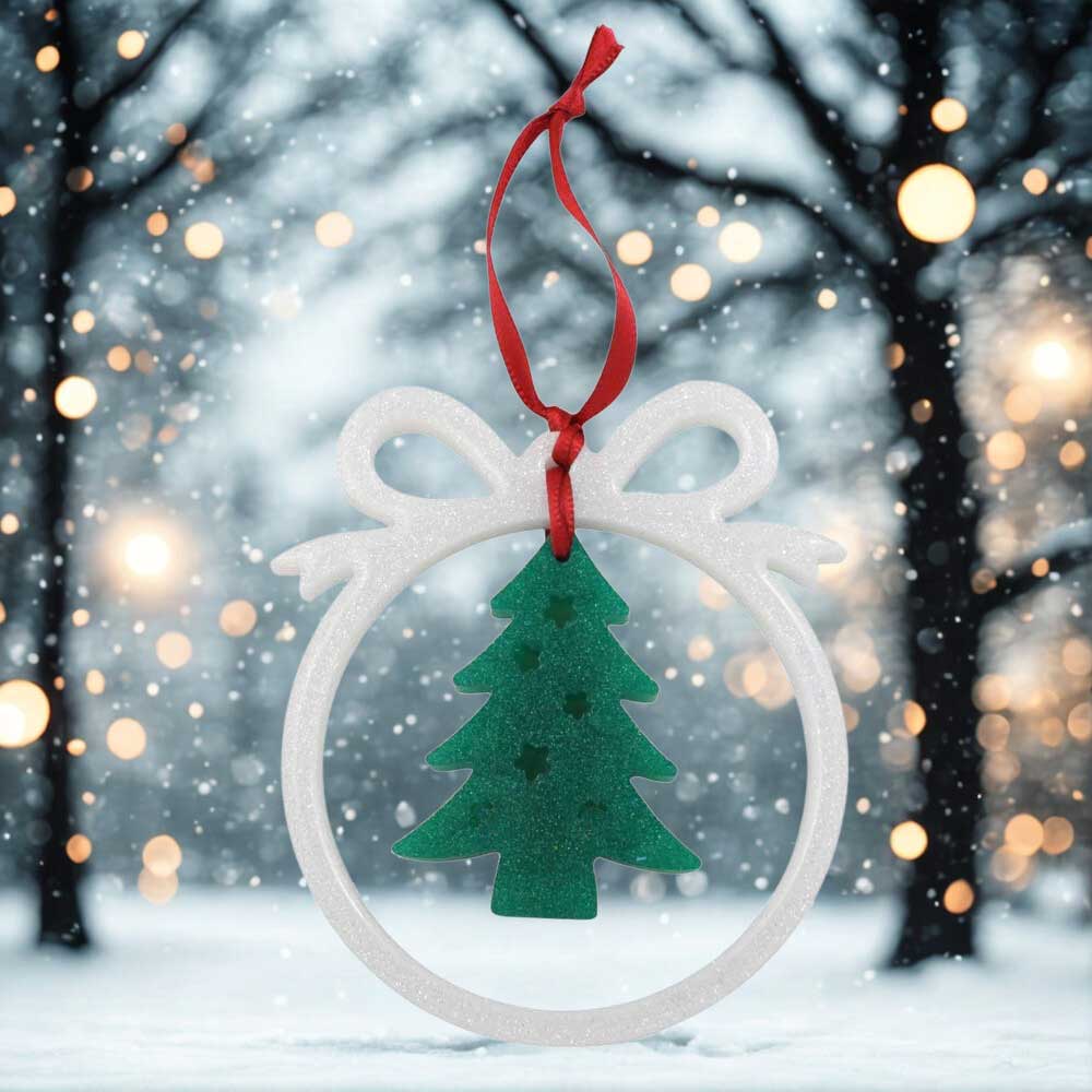 Open white bow with Christmas tree ornament on against a snowy background | Lilylin Designs