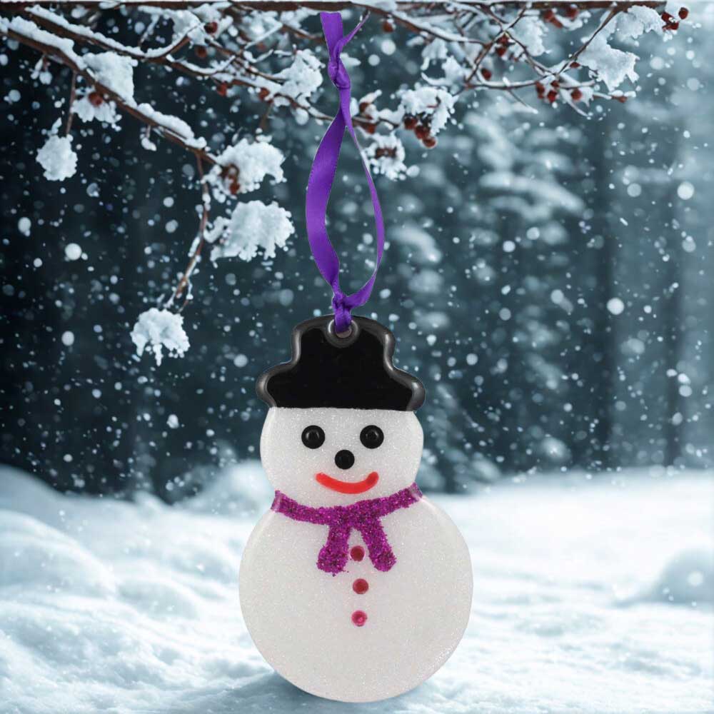 Decorative snowman ornament with a purple scarf against a snowy background | Lilylin Designs