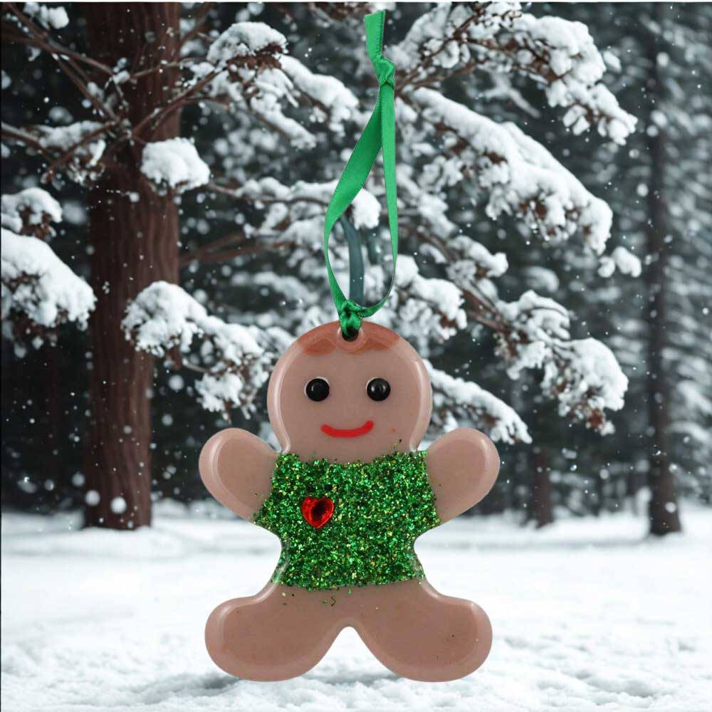 Gingerbread boy ornament with green glittery shirt and red heart on a snowy background | Lilylin Designs