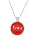 A silver chain necklace with a round pendant featuring a vibrant red face with the word 'Love' printed in white script, set against a plain white background - Lilylin Designs