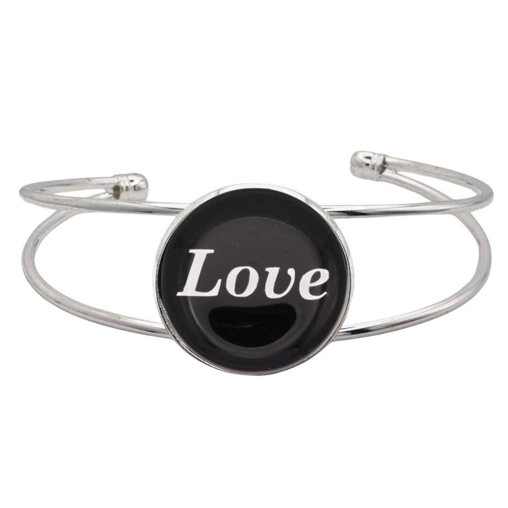 A silver-toned metal cuff bracelet featuring a round black disc with the word 'Love' printed in white script, shown on a plain white background – Lilylin Designs