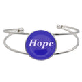 A silver-toned metal cuff bracelet featuring a round blue disc with the word 'Hope' printed in white script, shown on a plain white background – Lilylin Designs