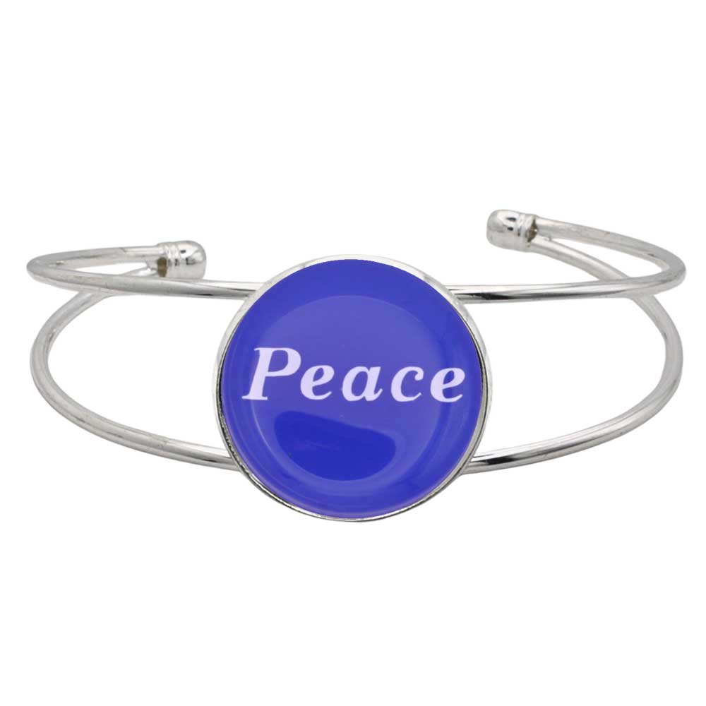A silver-toned metal cuff bracelet featuring a round blue disc with the word 'Peace' printed in white script, shown on a plain white background – Lilylin Designs