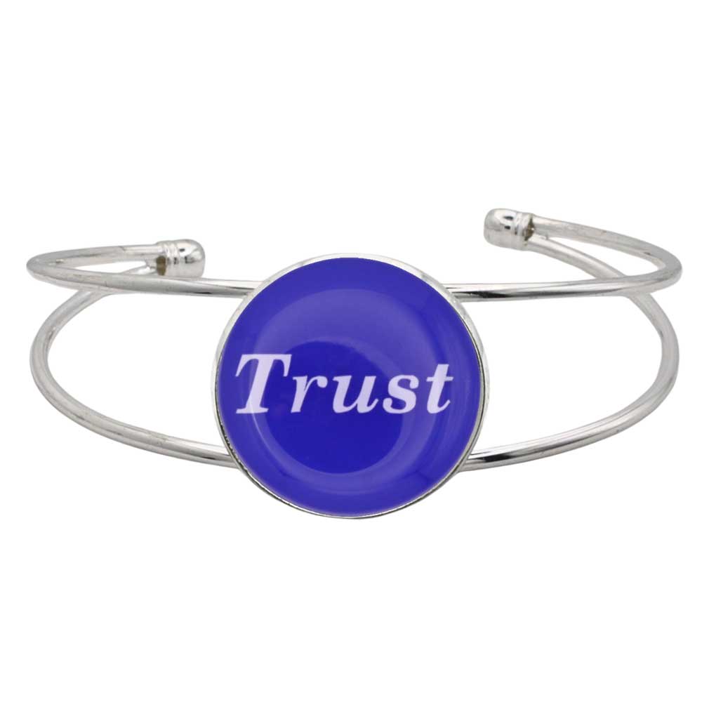 A silver-toned metal cuff bracelet featuring a round blue disc with the word 'Trust' printed in white script, shown on a plain white background – Lilylin Designs