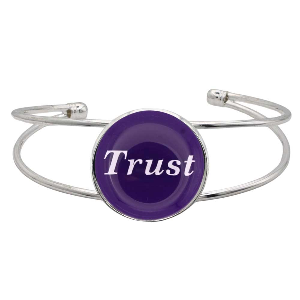 A silver-toned metal cuff bracelet featuring a round purple disc with the word 'Trust' printed in white script, shown on a plain white background – Lilylin Designs