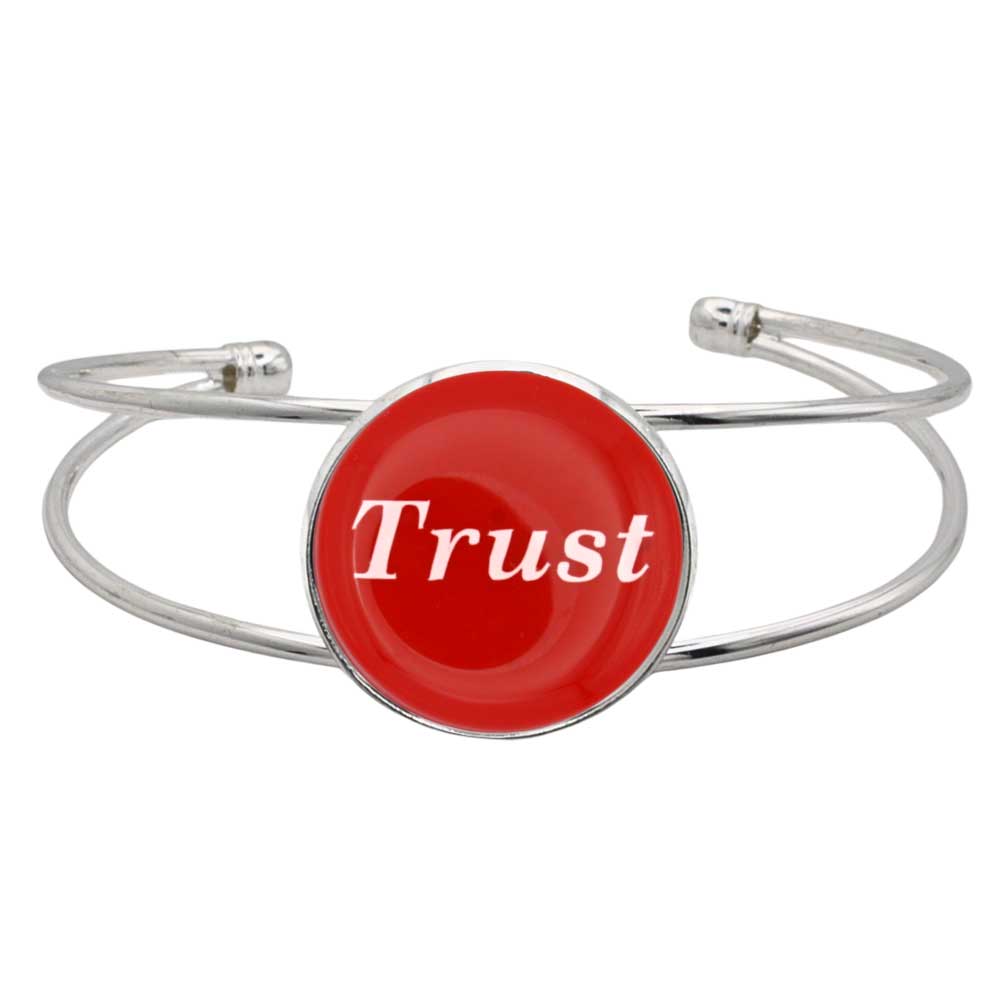 A silver-toned metal cuff bracelet featuring a round red disc with the word 'Trust' printed in white script, shown on a plain white background – Lilylin Designs
