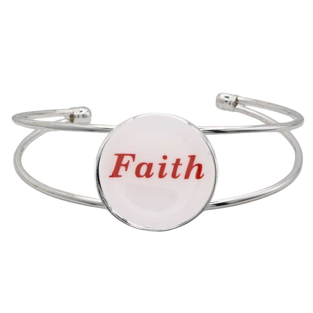 A silver-toned metal cuff bracelet featuring a round white disc with the word “Faith” printed in red script, shown on a plain white background – Lilylin Designs