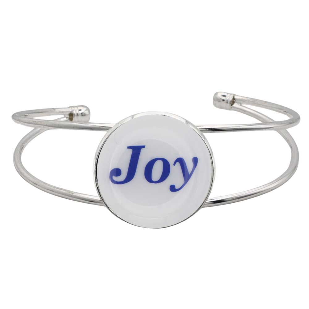 A silver-toned metal cuff bracelet featuring a round white disc with the word 'Joy' printed in blue script, shown on a plain white background – Lilylin Designs