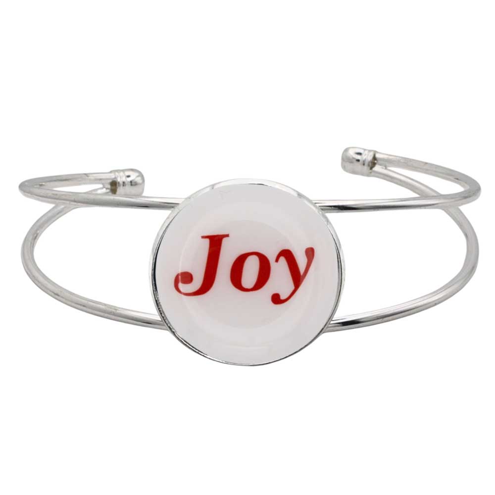 A silver-toned metal cuff bracelet featuring a round white disc with the word 'Joy' printed in red script, shown on a plain white background – Lilylin Designs