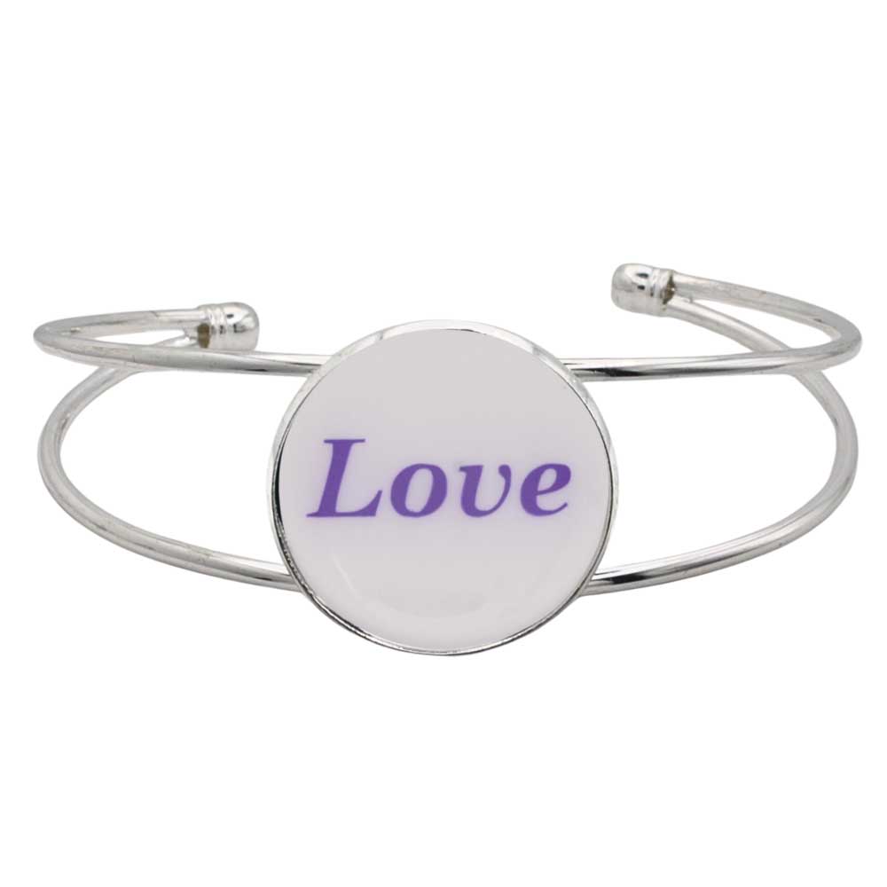 A silver-toned metal cuff bracelet featuring a round white disc with the word “Love” printed in purple script, shown on a plain white background – Lilylin Designs