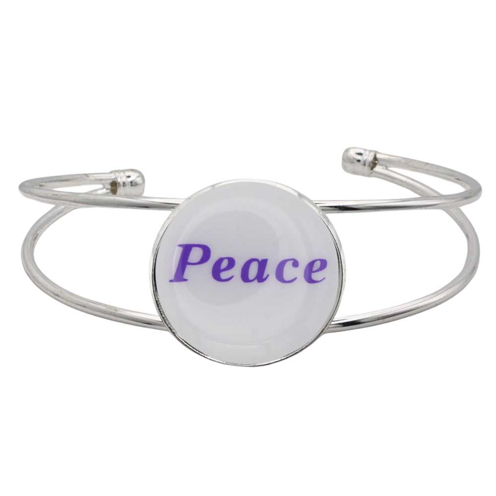 A silver-toned metal cuff bracelet featuring a round white disc with the word “Peace” printed in purple script, shown on a plain white background – Lilylin Designs