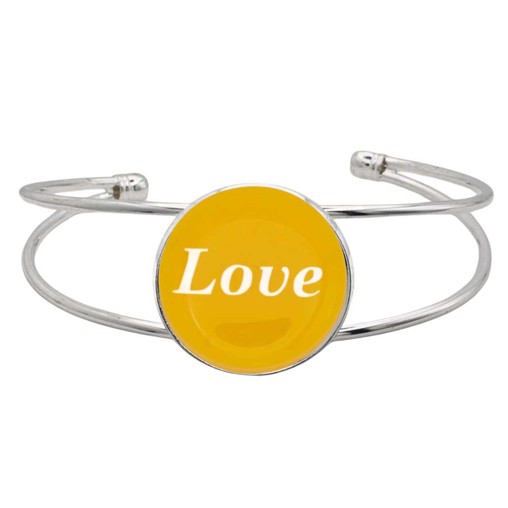 A silver-toned metal cuff bracelet featuring a round yellow disc with the word 'Love' printed in white script, shown on a plain white background – Lilylin Designs