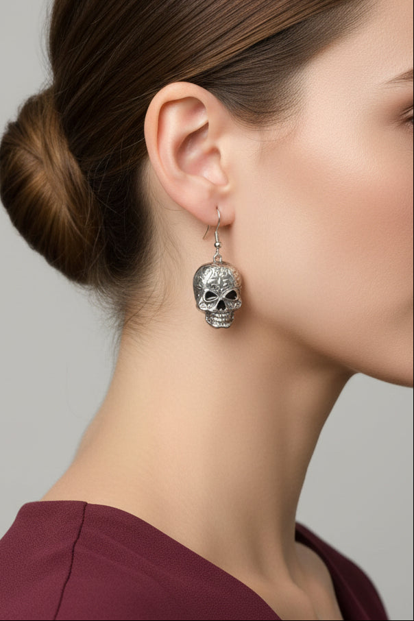 Model wearing antiqued patterned skull dangling pierced earring - Lilylin Designs