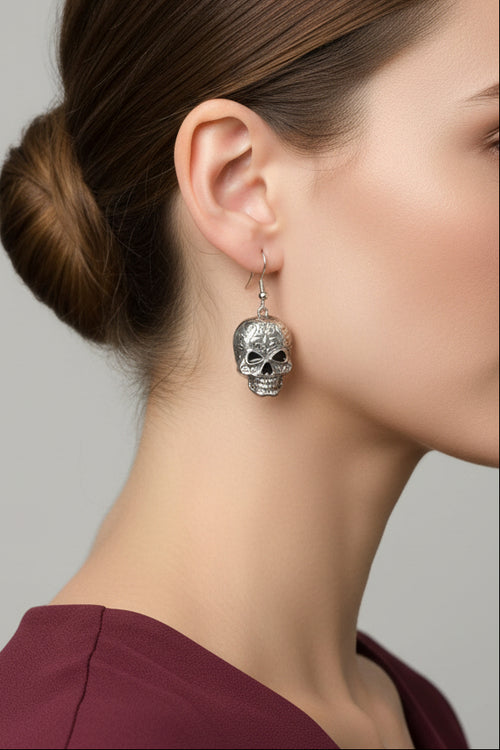 Model wearing antiqued patterned skull dangling pierced earring - Lilylin Designs