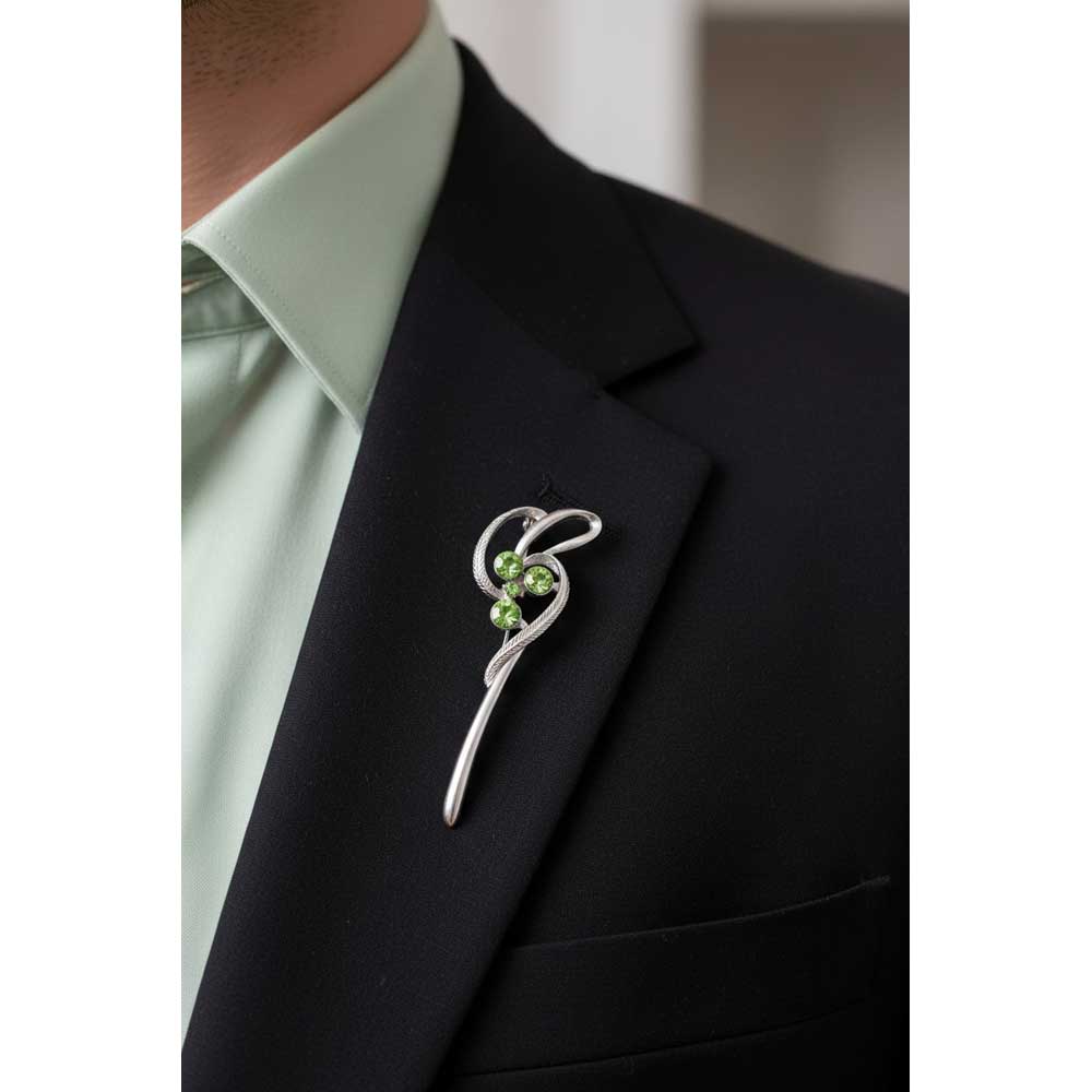 Model wearing silver abstract staff with light green crystals pin on a black jacket - Lilylin Designs