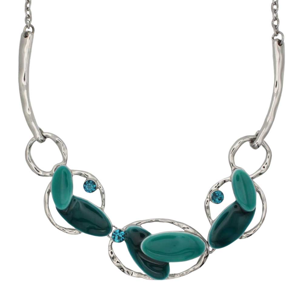 A silver-toned statement necklace featuring organic-shaped green and teal stone elements, accented by two small round blue stones, shown on a plain white background. Lilylin Designs