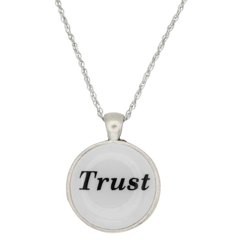 A silver necklace with a round pendant featuring the word 'Trust' in black serif lettering on a white background, shown against a plain white backdrop - Lilylin Designs