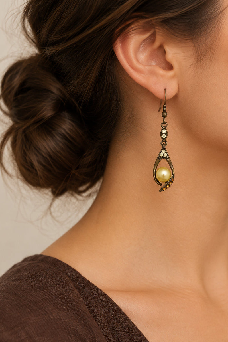 Model wearing yellow crystals with yellow pearl dangling pierced earring - Lilylin Designs