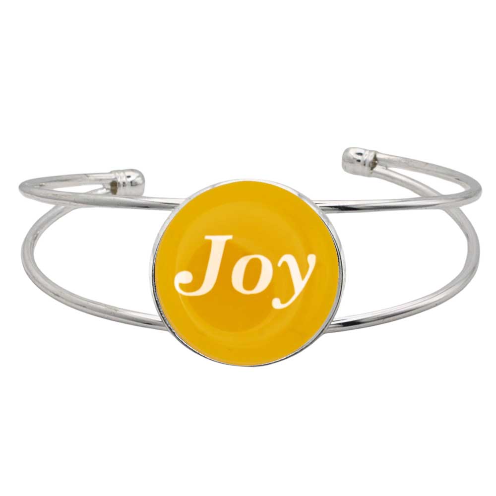 A silver-toned metal cuff bracelet featuring a round yellow disc with the word 'Joy' written in white script, shown on a plain white background - Lilylin Designs